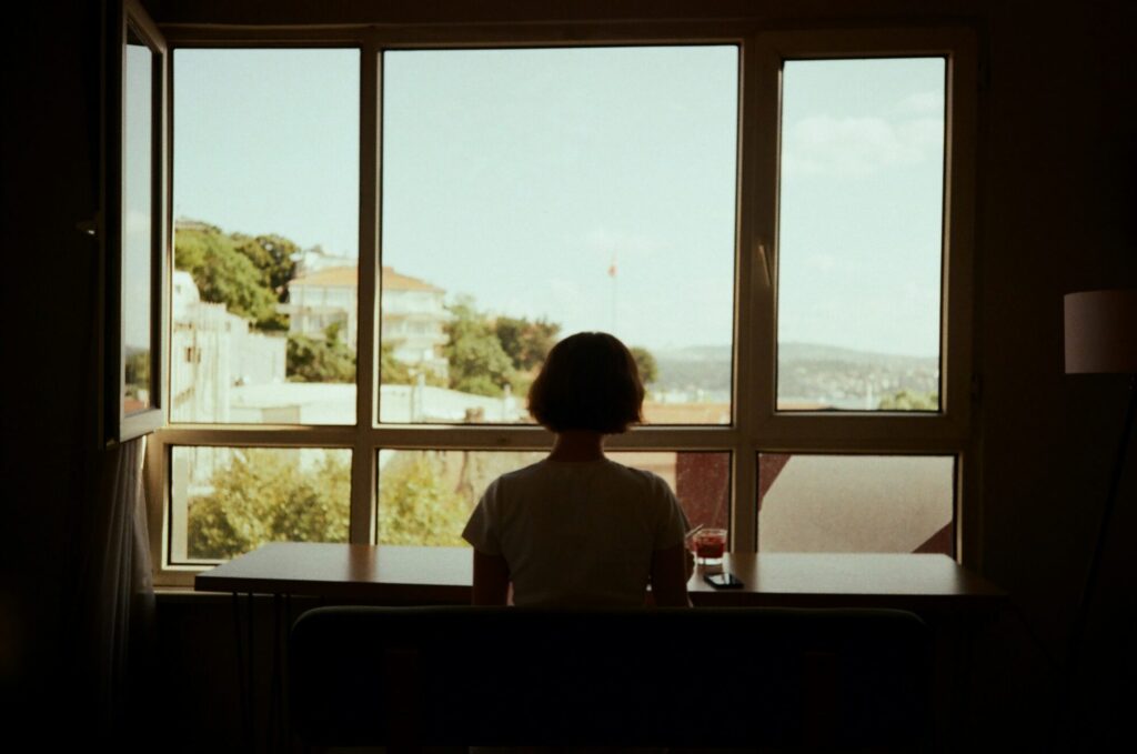 woman looking out window